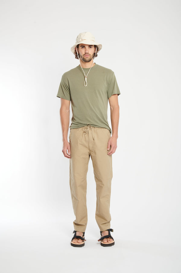 beige trousers with drawstring waistband.